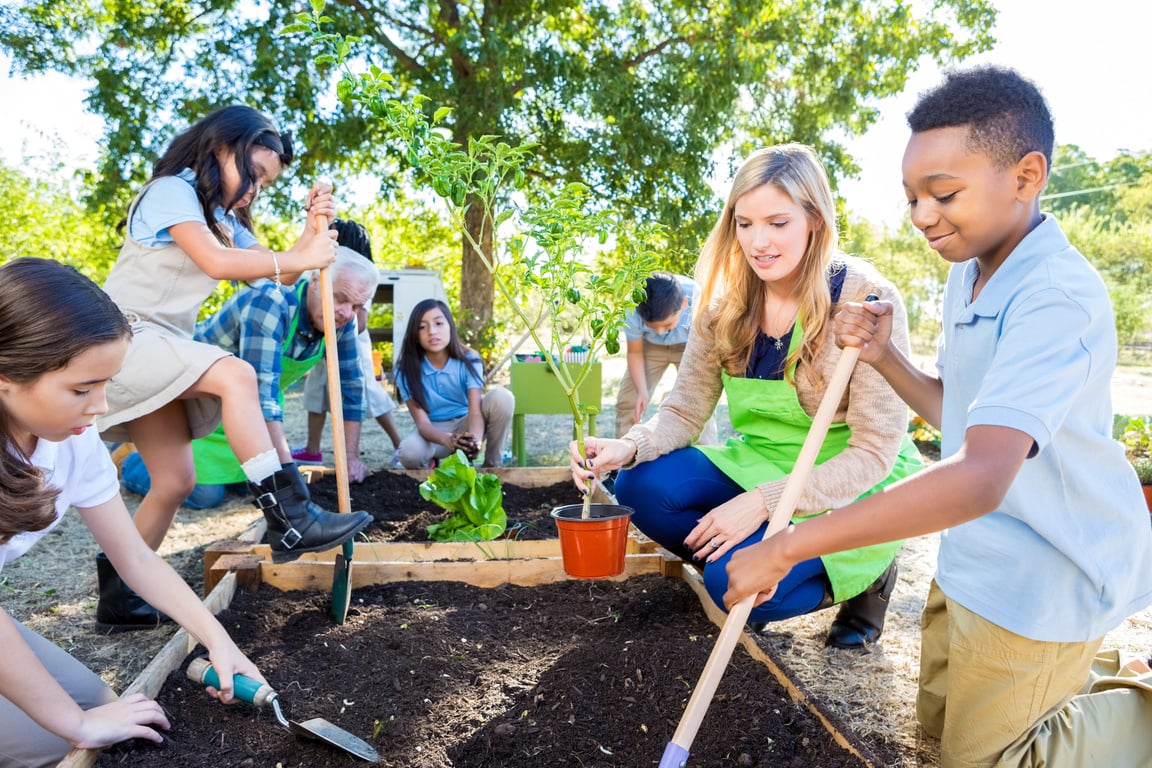 Teacher and students gardening during farm field trip